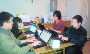 　　图为俞志晨(右一)和他的团队在简陋的工作室中研发软件。